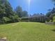 Exterior backyard view of the home with lawn and mature trees offering shade and privacy at 212 Hunting Court, Jonesboro, GA 30236