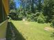 View of backyard with storage shed and tree line in the background, and a partial view of the house at 212 Hunting Court, Jonesboro, GA 30236