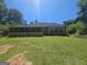 Backyard view of the home featuring a screened porch and large windows for natural light at 212 Hunting Court, Jonesboro, GA 30236