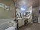 Bathroom featuring a garden tub, a walk-in shower, and double sink vanity with great lighting at 212 Hunting Court, Jonesboro, GA 30236