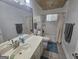 Bathroom featuring a single sink vanity and a shower/tub combo with white tile surround at 212 Hunting Court, Jonesboro, GA 30236