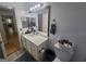 Bathroom with a white single sink vanity, toilet, and access to the rest of the home at 212 Hunting Court, Jonesboro, GA 30236