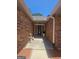 Inviting home entrance featuring brick walls, decorative lighting, and a stylish front door at 212 Hunting Court, Jonesboro, GA 30236