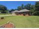 Well-maintained single-story brick home with a two-car garage and mature landscaping in the front yard at 212 Hunting Court, Jonesboro, GA 30236