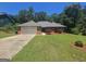 Charming single-story brick home with a well-maintained lawn and attached two-car garage at 212 Hunting Court, Jonesboro, GA 30236