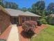 Well-manicured front yard with lush landscaping leading to the brick home's inviting entrance at 212 Hunting Court, Jonesboro, GA 30236