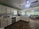 Bright kitchen featuring white cabinets, countertops, stainless steel appliances, and tile floors at 212 Hunting Court, Jonesboro, GA 30236