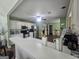 Open kitchen with white cabinets, stainless steel appliances, breakfast bar, and tile flooring at 212 Hunting Court, Jonesboro, GA 30236