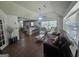Open-concept living room with tile flooring and abundant natural light from large windows at 212 Hunting Court, Jonesboro, GA 30236