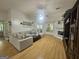 Bright living room featuring hardwood flooring, a fireplace, and comfortable furniture at 212 Hunting Court, Jonesboro, GA 30236