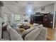 Cozy living room with fireplace, hardwood flooring, and large windows provides natural light at 212 Hunting Court, Jonesboro, GA 30236