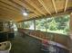 View from the screened in porch to the backyard; ceiling fans plus comfortable seating shown at 212 Hunting Court, Jonesboro, GA 30236