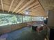 Spacious screened porch with unfinished ceiling, ceiling fans, furniture, and a view of the backyard at 212 Hunting Court, Jonesboro, GA 30236