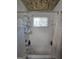 Shower/Tub combo featuring a shower head and tiled walls and a window above the tub at 212 Hunting Court, Jonesboro, GA 30236