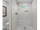 Walk-in shower features gray and white marble tile, a bench, a window and bronze fixtures at 317 Mcpherson Se Pl, Atlanta, GA 30316