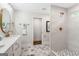Stylish bathroom featuring marble-style floors, double vanity, and a glass enclosed shower at 317 Mcpherson Se Pl, Atlanta, GA 30316