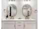 Bathroom with a double vanity, gold accents, and two oval mirrors at 317 Mcpherson Se Pl, Atlanta, GA 30316
