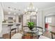 Inviting dining area with a modern chandelier, perfect for Gathering meals and entertaining guests with kitchen view at 317 Mcpherson Se Pl, Atlanta, GA 30316
