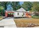 Charming craftsman home with attached carport and inviting front porch with wooden steps at 317 Mcpherson Se Pl, Atlanta, GA 30316