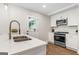 Bright kitchen features white cabinets, stainless appliances, and an attractive faucet and countertop at 317 Mcpherson Se Pl, Atlanta, GA 30316