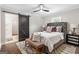 Comfortable bedroom boasts a ceiling fan, barn door to ensuite bathroom, and a sitting bench at 317 Mcpherson Se Pl, Atlanta, GA 30316