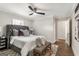 Comfortable bedroom boasts a ceiling fan and an upholstered bed with decorative pillows at 317 Mcpherson Se Pl, Atlanta, GA 30316