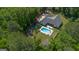 Aerial view of a home with an in-ground pool and fenced in backyard surrounded by greenery at 11807 Alcovy Rd, Covington, GA 30014