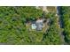 Aerial view of a home featuring an in-ground pool surrounded by a dense green forest at 11807 Alcovy Rd, Covington, GA 30014