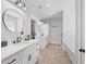 Elegant bathroom with dual sink vanities, marble countertops, and modern fixtures at 11807 Alcovy Rd, Covington, GA 30014