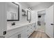 Bright bathroom with double vanity, white cabinets, framed mirrors, and modern fixtures at 11807 Alcovy Rd, Covington, GA 30014