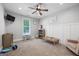 Inviting bedroom with a large window, neutral carpet and a ceiling fan for comfort at 11807 Alcovy Rd, Covington, GA 30014