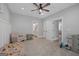 Inviting bedroom featuring a view to the ensuite bathroom, neutral carpet and a ceiling fan at 11807 Alcovy Rd, Covington, GA 30014
