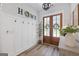 Inviting foyer with board and batten walls, decorative hooks, modern lighting, and a charming double-door entryway at 11807 Alcovy Rd, Covington, GA 30014