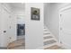 Inviting hallway featuring a convenient laundry room and staircase with wood and white trim at 11807 Alcovy Rd, Covington, GA 30014
