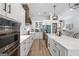 Elegant kitchen with double ovens, custom cabinetry, a large center island with a farmhouse sink, and modern finishes at 11807 Alcovy Rd, Covington, GA 30014