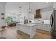Stylish kitchen with stainless appliances, custom cabinetry, a large center island, and a dining area with backyard views at 11807 Alcovy Rd, Covington, GA 30014