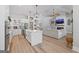 Bright open-concept living room with an island kitchen, wood floors, and modern farmhouse design elements at 11807 Alcovy Rd, Covington, GA 30014