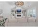 Spacious living room with modern fireplace, large sectional sofa, and unique ceiling fan, perfect for Gathering gatherings at 11807 Alcovy Rd, Covington, GA 30014