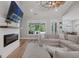 Bright living room showcasing a modern fireplace, backyard pool view, and open access to the dining area, ideal for entertaining at 11807 Alcovy Rd, Covington, GA 30014