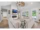 Open-concept living room with a modern fireplace, unique ceiling fan, and a large sectional sofa, offering comfort and style at 11807 Alcovy Rd, Covington, GA 30014