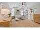 Bright main bedroom featuring tray ceiling, neutral colors, and barn door access to ensuite bathroom at 11807 Alcovy Rd, Covington, GA 30014