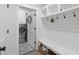 Well-organized mudroom with built-in storage, bench, and decorative accents at 11807 Alcovy Rd, Covington, GA 30014