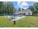 Home with in-ground pool, lounge chairs, lush landscaping and a covered patio at 11807 Alcovy Rd, Covington, GA 30014