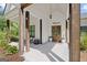 Inviting front porch with wood columns, a 'welcome' sign, double wood doors, and tasteful decor for a warm ambiance at 11807 Alcovy Rd, Covington, GA 30014