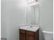 Simple bathroom vanity with mirror and light fixtures offers essential amenities at 11439 South Grove Dr, Hampton, GA 30228