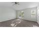 Sunlit bedroom with carpet, fan, and windows creating a bright and inviting atmosphere at 11439 South Grove Dr, Hampton, GA 30228