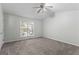 Spacious bedroom with neutral carpet, fan, and a window allowing natural light at 11439 South Grove Dr, Hampton, GA 30228