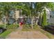 Charming townhome featuring stone accents, colorful door, mature trees and a convenient parking pad at 11439 South Grove Dr, Hampton, GA 30228