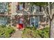 Charming exterior featuring a stone facade, a bright red door, and well-maintained landscaping at 11439 South Grove Dr, Hampton, GA 30228
