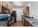 Well-lit kitchen features wood cabinets, stainless steel appliances, and sleek black countertops at 11439 South Grove Dr, Hampton, GA 30228